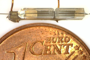Image of the optical fibre resonator compared to the size of a Euro Cent coin.
