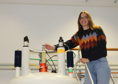 Photo of Anika Mauel on top of spectrometer magnet