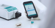 Photo of the Metrohm Instant SERS Analyzer and app on phone